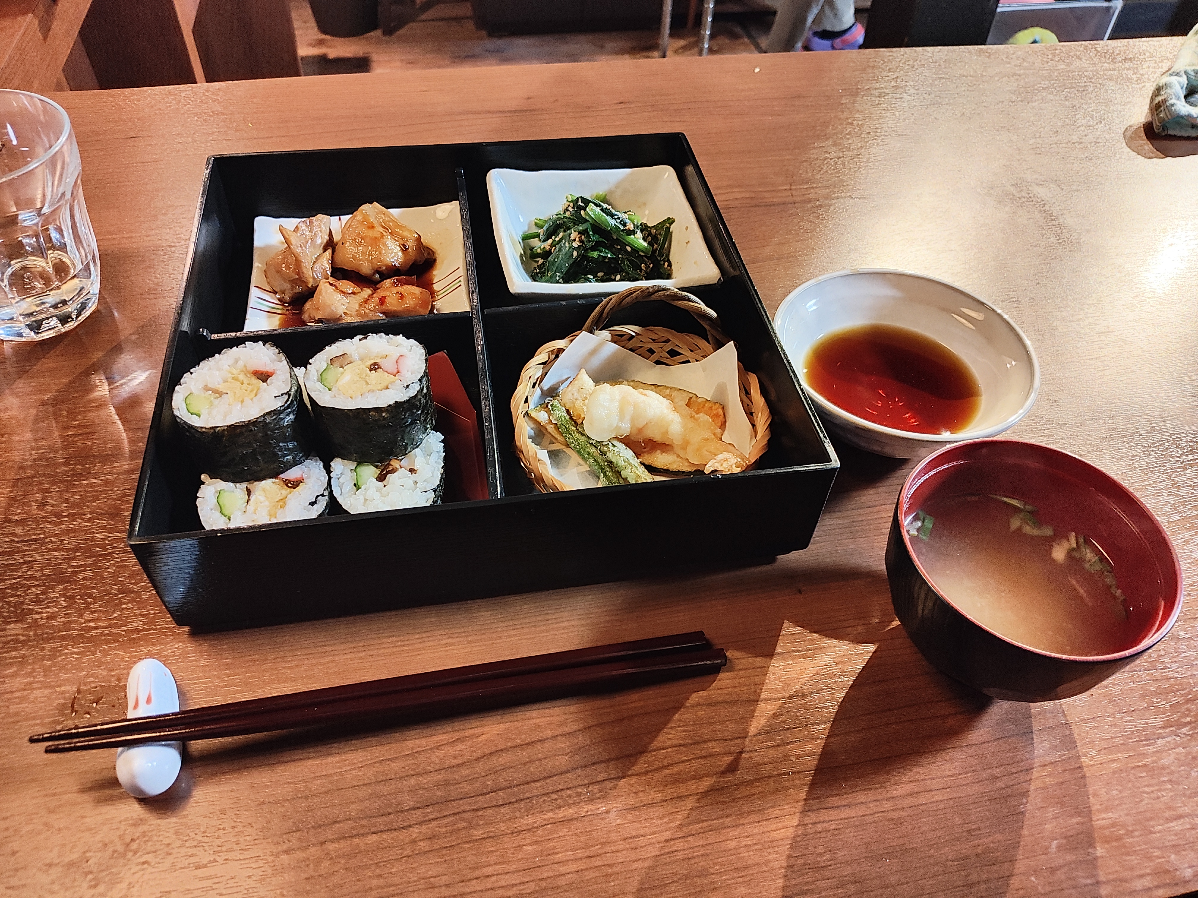 My bento! From top right to bottom left - Teriyaki chicken; spinach salad; sushi with egg, cucumber, imitation crab and pickled vegetables; tempura pumpkin, green beans, and shrimp; dipping sauce for the tempura, and miso soup.